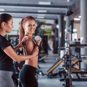 depositphotos_522357536-stock-photo-female-personal-trainer-helping-woman