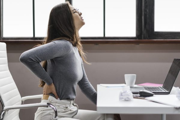 side-view-woman-having-backache-while-working-from-home